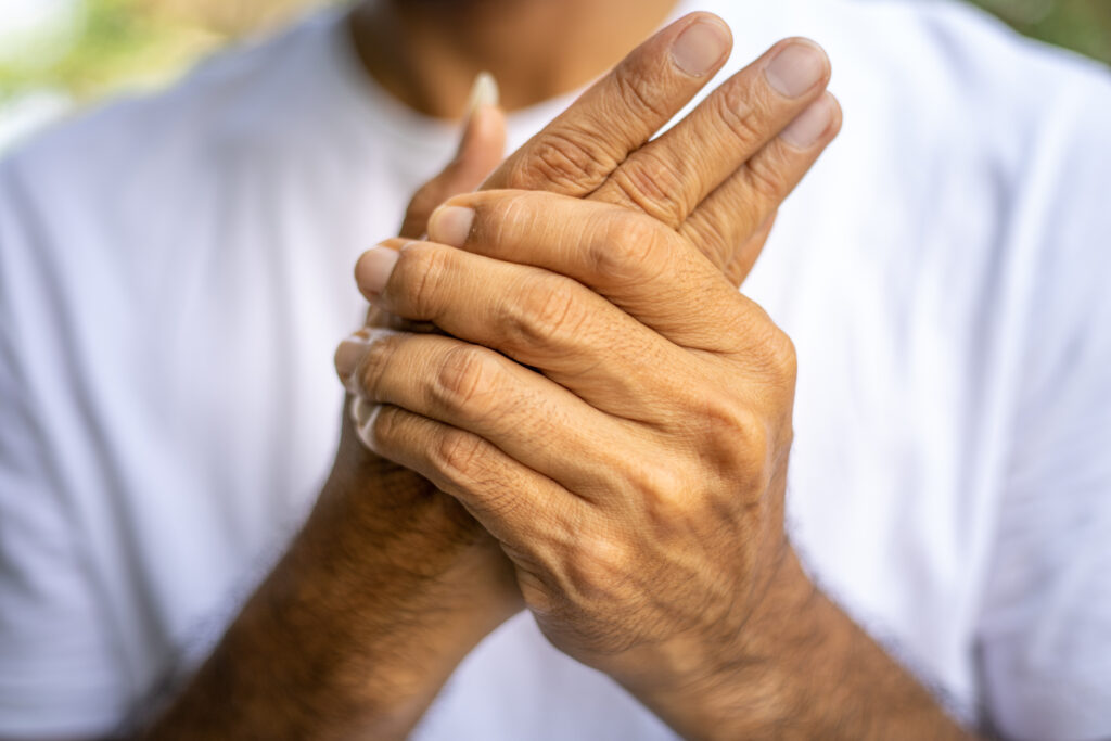 Close-up of an older adult’s hands, highlighting the impact of arthritis and mobility challenges common with aging and diabetes.