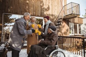 Close up of a group of seniors having hot tea while enjoying time together on the porch during winter