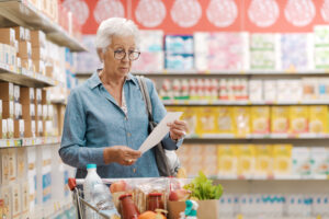 Disappointed senior customer checking the grocery receipt
